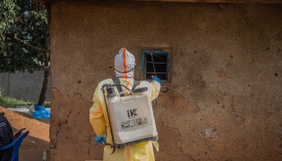 Medical worker performing disinfection before burying deceased person infected with Ebola in DR Congo. Xinhua file photo.