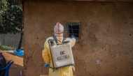 A medical worker performs disinfection before burying a deceased person infected with the Ebola virus in Bunia, the capital of Ituri Province in the Democratic Republic of the Congo, July 9, 2026. (Xinhua)