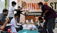 Cockroach Janta Party (CJP) founder Abhijeet Dipke (2R) reacts as doctors check activist Sonam Wangchuk vital signs during his hunger strike in New Delhi on July 15, 2026, demanding the resignation of India Education Minister Dharmendra Pradhan over alleged examination irregularities. (Photo by Arun SANKAR / AFP)
 