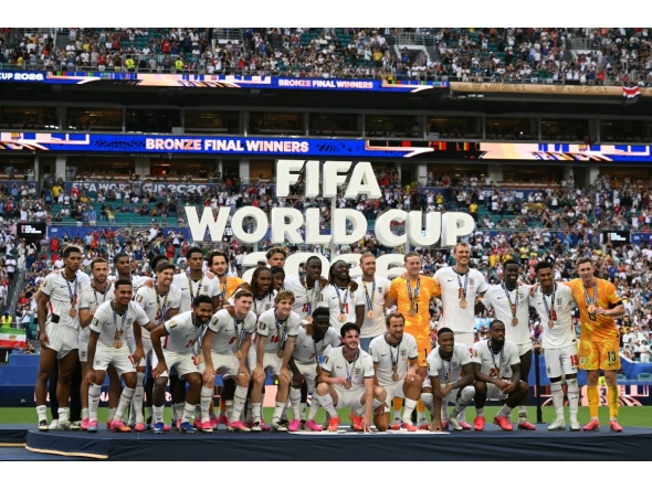 England's players pose for a photo with their medals after winning the 2026 World Cup football tournament third-place match between France and England at the Miami Stadium in Miami on July 18, 2026. (Photo by CHANDAN KHANNA / AFP)