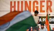 Cockroach Janta Party (CJP) founder Abhijeet Dipke (R) sits on an indefinite hunger strike demanding the resignation of India's Education Minister Dharmendra Pradhan over alleged NEET examination irregularities in New Delhi on July 19, 2026. (Photo by Sajjad Hussain / AFP)
 