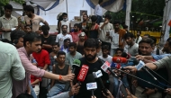 Cockroach Janta Party (CJP) founder Abhijeet Dipke speaks to the media during a protest demanding the resignation of India's Education Minister Dharmendra Pradhan over alleged NEET exam irregularities, in New Delhi on July 21, 2026. (Photo by Arun Sankar / AFP)