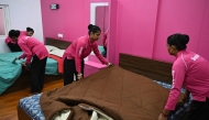 This photograph taken on June 22, 2026 shows employees of the on-demand home-services platform Snabbit, making beds at the company's training centre in Bengaluru. (Photo by Idrees Mohammed / AFP)
 