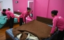 This photograph taken on June 22, 2026 shows employees of the on-demand home-services platform Snabbit, making beds at the company's training centre in Bengaluru. (Photo by Idrees Mohammed / AFP)
 