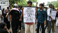A Cockroach Janta Party (CJP) supporter holds a placard at Jantar Mantar in New Delhi on July 22, 2026. (Photo by Sajjad Hussain / AFP)
