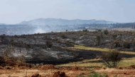 Smoke from a wildfire is seen near the town of Albendiego, in the Guadalajara province north of Madrid, on July 22, 2026. A wildfire that broke out on July 16 in La Mierla area, near Guadalajar has devastated 32,000 hectares and caused the evacuation of several hundred people. (Photo by Pierre-Philippe MARCOU / AFP)