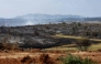 Smoke from a wildfire is seen near the town of Albendiego, in the Guadalajara province north of Madrid, on July 22, 2026. A wildfire that broke out on July 16 in La Mierla area, near Guadalajar has devastated 32,000 hectares and caused the evacuation of several hundred people. (Photo by Pierre-Philippe MARCOU / AFP)