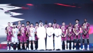 Qatar Volleyball Association President Ali bin Ghanim Al Kuwari ad officials pose for a photo with Qatar players.