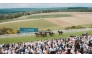 Crowds cheer as horses compete during a race at the 2025 Goodwood Festival.