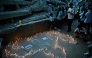 Relatives light candles during a mass for the victims in Caraballeda, Venezuela, on July 24, 2026, one month after an earthquake struck the area. (Photo by Federico PARRA / AFP)