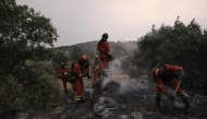Firefighters battle a wildfire in Zarzalejo area, near El Escorial, 60 kms northwest of Madrid in the morning of July 25, 2026. Spanish firefighters hoped to get control of wildfires raging near Madrid on Saturday but an official warned that erratic winds threatened to fan the blazes further. (Photo by Oscar DEL POZO / AFP)
 