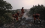 Firefighters battle a wildfire in Zarzalejo area, near El Escorial, 60 kms northwest of Madrid in the morning of July 25, 2026. Spanish firefighters hoped to get control of wildfires raging near Madrid on Saturday but an official warned that erratic winds threatened to fan the blazes further. (Photo by Oscar DEL POZO / AFP)
 