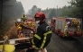 Firefighters operate from a column of firefighters vehicles near the town of Lacanau, in southwestern France on July 25, 2026. (Photo by Julien De Rosa / AFP)