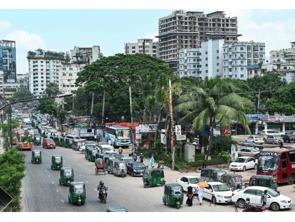 Vehicles wait in a queue to refuel with compressed natural gas (CNG) at a filling station in Dhaka on July 26, 2026. (Photo by MUNIR UZ ZAMAN / AFP)
