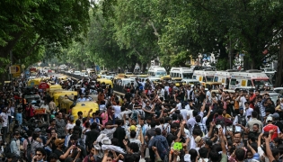 Cockroach Janta Party (CJP) supporters celebrate the resignation of India's Education Minister Dharmendra Pradhan, at Jantar Mantar in New Delhi on July 25, 2026.  (Photo by Sajjad HUSSAIN / AFP)
