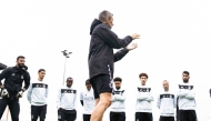 Al Sadd's coach Razvan Lucescu with players during a training session yesterday.