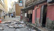 The exterior wall of a shop is seen collapsed in an earthquake, in Kumamoto City on July 28, 2026. (Photo by JIJI Press / AFP) / Japan OUT