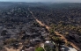 his general aerial view taken with a drone shows a burnt forest in Pelayos de la Presa, 65 kilometres west of Madrid, following devastating wildfires in the region on July 30, 2026.  (Photo by OSCAR DEL POZO / AFP)
