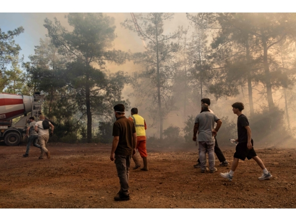 Volunteers and firefighters battle a wildfire in Fethiye, in the province of Mugla, southwestern Turkey on July 30, 2026. (Photo by Murat Kocabas / AFP)