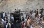 Coal miners and relatives gather at the entrance of a coal mine after it collapsed in the Surange area, some 50 kilometres east of Quetta, on July 30, 2026. (Photo by Banaras Khan / AFP)