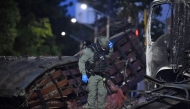 A police officer inspects the wreckage of a truck after a car bomb detonated near a police station in Cucuta, Colombia, on August 1, 2026. (Photo by Schneyder Mendoza / AFP)