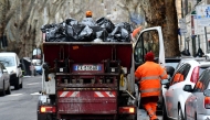 This illustration picture shows an employee of Rome's garbage collection 