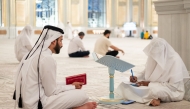 A participant with a teacher during a session of the Quran recitation programme.