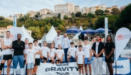 The participating high jumpers pose for a photo with junior athletes ahead of the event.
