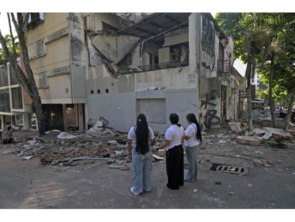Women look at a damaged building after an earthquake in Cali, Colombia on August 10, 2026. Photo by JOAQUIN SARMIENTO / AFP