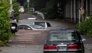 Abandoned cars partially submerged on a flooded road in Chiba prefecture. AFP file photo.