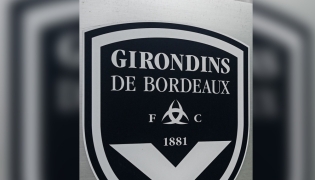 (FILES) This general view taken on May 19, 2022, shows a sign with a logo in front of the chateau of FC Girondins de Bordeaux at the club's training ground in Le Haillan, near Bordeaux, south-western France. (Photo by Philippe LOPEZ / AFP)