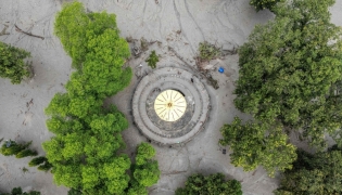 This aerial photograph shows the Neelkantha Hindu temple covered heavily under sludge in the aftermath of flash floods at Devighat in Nepal's Nuwakot district on August 29, 2026. (Photo by Manan VATSYAYANA / AFP)