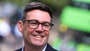 Britain's Prime Minister Andy Burnham smiles during a visit to Bath, western England, on July 22, 2026. Photo by Toby Melville / POOL / AFP