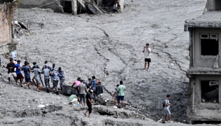 Rescue personnel pull out a locker from a deluged bank after flash floods at Trishuli Center in Nepal's Nuwakot district on September 1, 2026. T(Photo by Arun SANKAR / AFP)
