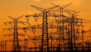 This picture taken on November 12, 2025 shows power poles near the lignite-fired power station operated by German energy giant RWE near Niederaussem, part of Bergheim, western Germany. Photo by Ina FASSBENDER / AFP