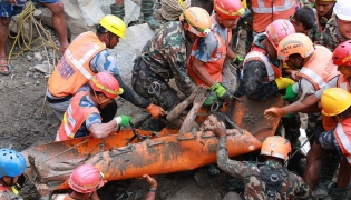 This handout photograph taken and released by the Nepal Army on September 4, 2026 shows army personnel carrying a worker who was trapped inside a tunnel, during a rescue operation at Trishuli-3A Hydropower Project in Nepal's Rasuwa district. Photo by Handout / NEPAL ARMY / AFP