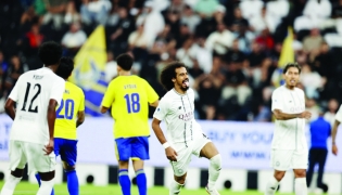Al Sadd's Akram Afif (second right) celebrates after scoring a goal.