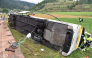This handout photograph released on September 11, 2026 by the Swiss Police of Canton Graubunden shows the wreckage of a bus after an accident in between the village of Susch and Zernez, eastern Switzerland, on September 10, 2026. (Photo by Handout / KANTONPOLIZEI GRAUBUNDEN / AFP) 