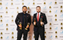 Ahmed Alkahlout and Fajir Abdul Majeed pose with the awards during the ceremony.