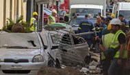 Emergency personnel operate at the site of an old building that partially collapsed following an explosion in the Plaka area of central Athens on September 25, 2026. (Photo by Aris MESSINIS / AFP)