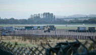 An armoured vehicle (C) patrols the interior at RAF Fairford base in Fairford, south-west England on September 28, 2026. (Photo by Ben Stansall / AFP)