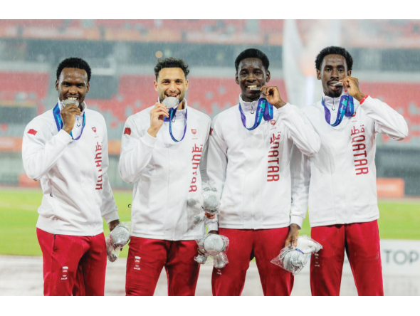 Qatar’s 4x400m relay quartet of Ammar Ibrahim, Bassem Hemeida, Youssef Djibrine and Ismail Abakar celebrate on the podium.