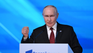 Russia's President Vladimir Putin gestures as he addresses the audience during the Valdai Discussion Club meeting in Moscow on October 1, 2026. (Photo by Igor IVANKO / AFP)
