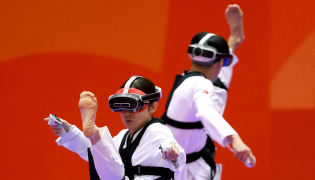 Japan's Nakajima Miho (L) competes against compatriot Suzuki Hayate (R) in the mixed individual virtual taekwondo round 16 during the 2026 Asian Games at the Toyohashi Gymnasium in Toyohashi on October 2, 2026. (Photo by DAVID GRAY / AFP)