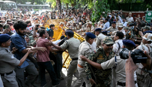 Protesters and All India Students' Association (AISA) supporters scuffle with police personnel during a demonstration against India's Chief Election Commissioner Gyanesh Kumar in New Delhi on October 3, 2026, to demand his resignation over alleged irregularities in the Special Intensive Revision (SIR) of electoral rolls. (Photo by Arun SANKAR / AFP)