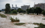 The swollen Besos River flows through Sant Adria de Besos following torrential rains on the outskirts of Barcelona, on October 4, 2026. (Photo by Josep Lago / AFP)