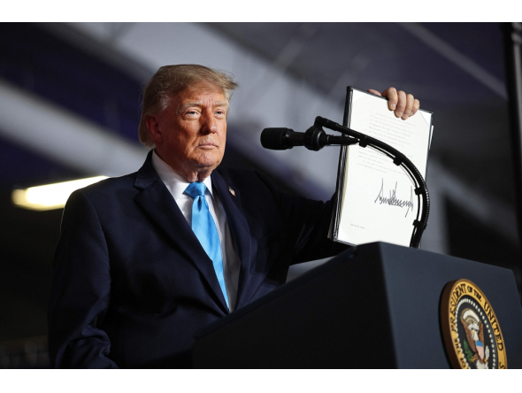 US President Donald Trump signs an executive order to lower the cost of diesel fuel on October 05, 2026 in Grand Island, Nebraska. Win McNamee/Getty Images/AFP