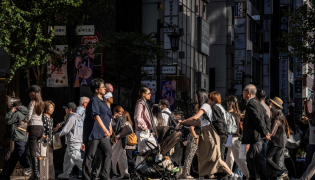 People cross a street in Ginza area of Tokyo on October 8, 2026. (Photo by Yuichi YAMAZAKI / AFP)