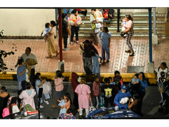 People carrying babies evacuate the Children's Hospital after a magnitude 6.0 aftershock is felt following a magnitude 7.6 earthquake in Panama City, Panama, on October 9, 2026. (Photo by Martin Bernetti / AFP)