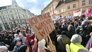 (Files) A protester holds a placard reading 